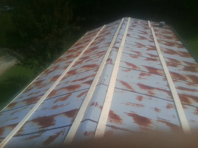 Rusted metal roof panels with new wood purlins before replacement — Storm Damage Roof Repair in Daleville by Roofing Brothers